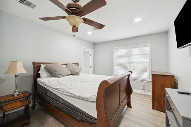 a bedroom with a bed and a flat screen tv