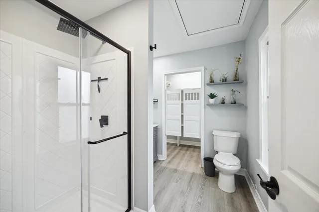 a bathroom with a toilet and a shower