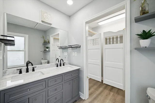 a bathroom with a double vanity sink a mirror and shower