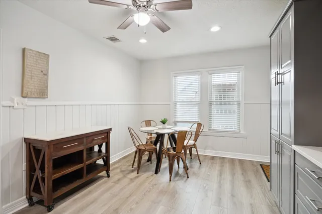 a view of a dining room with furniture and chandelier