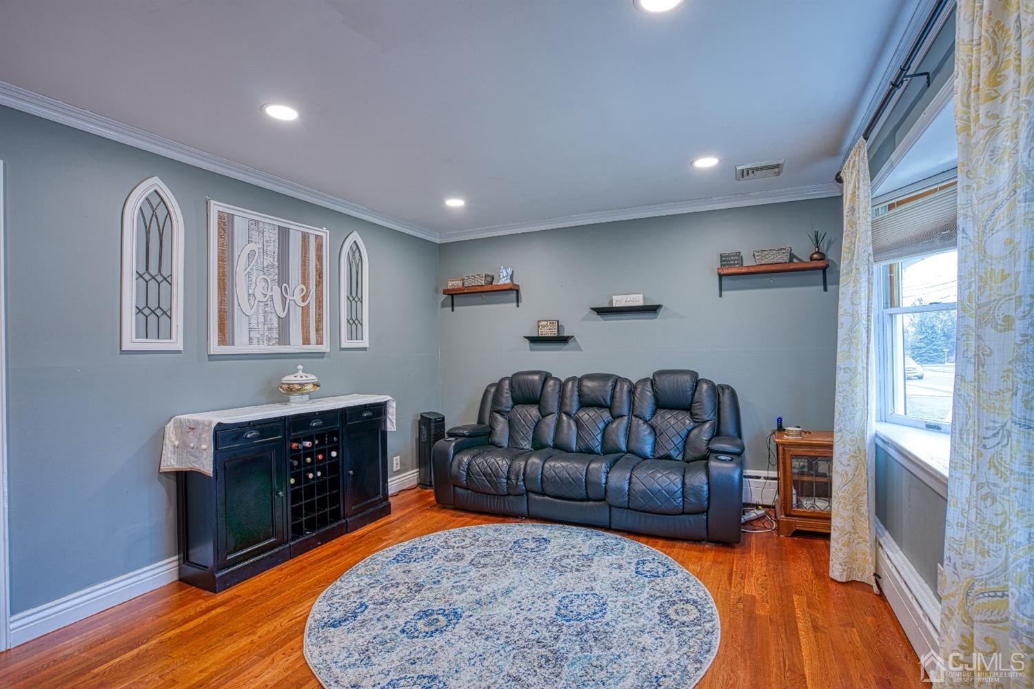 a living room with furniture rug and wooden floor