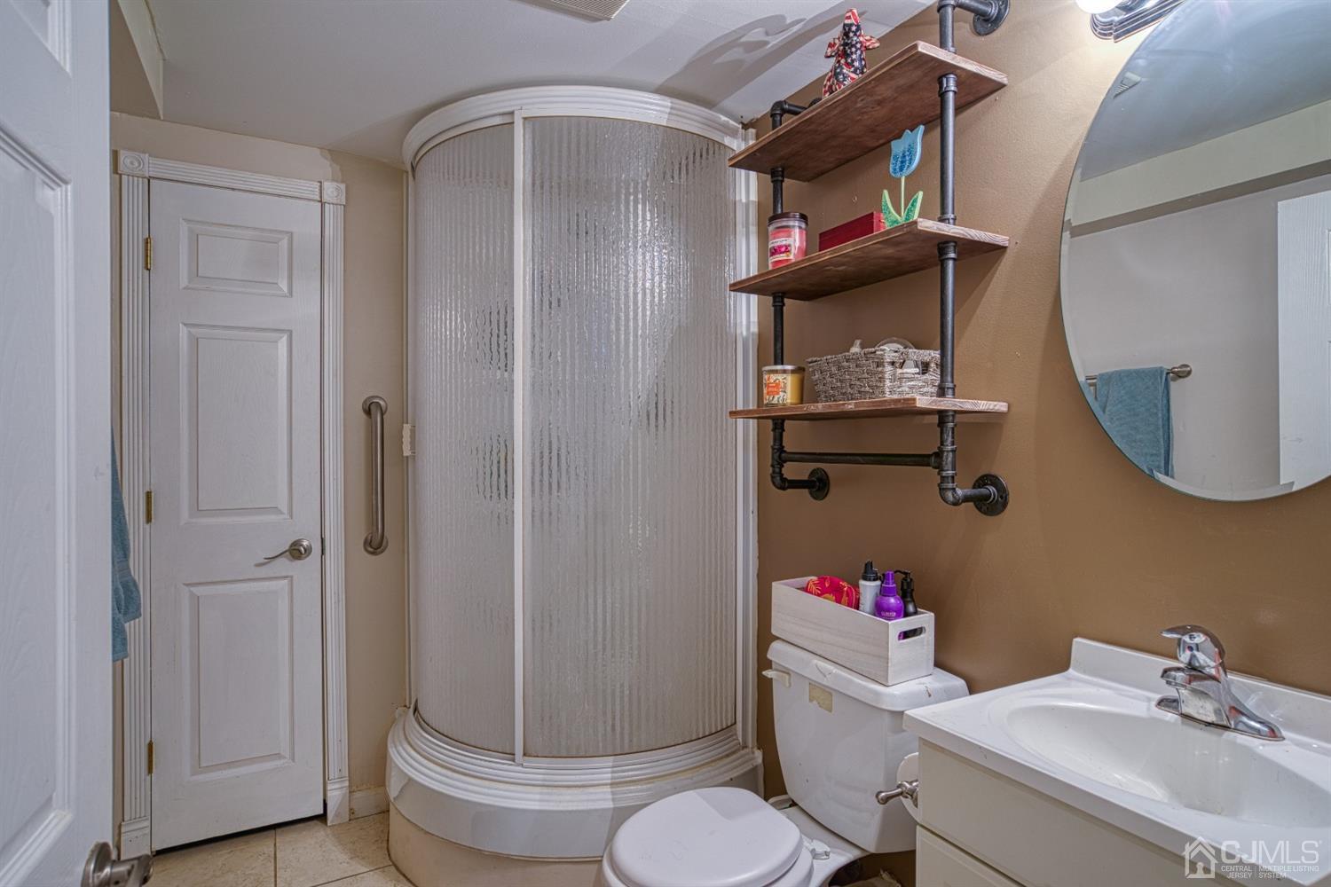 8 Clausen Road Edison, NJ 08817 - Photo 13 of 17 a bathroom with a sink mirror vanity and toilet
