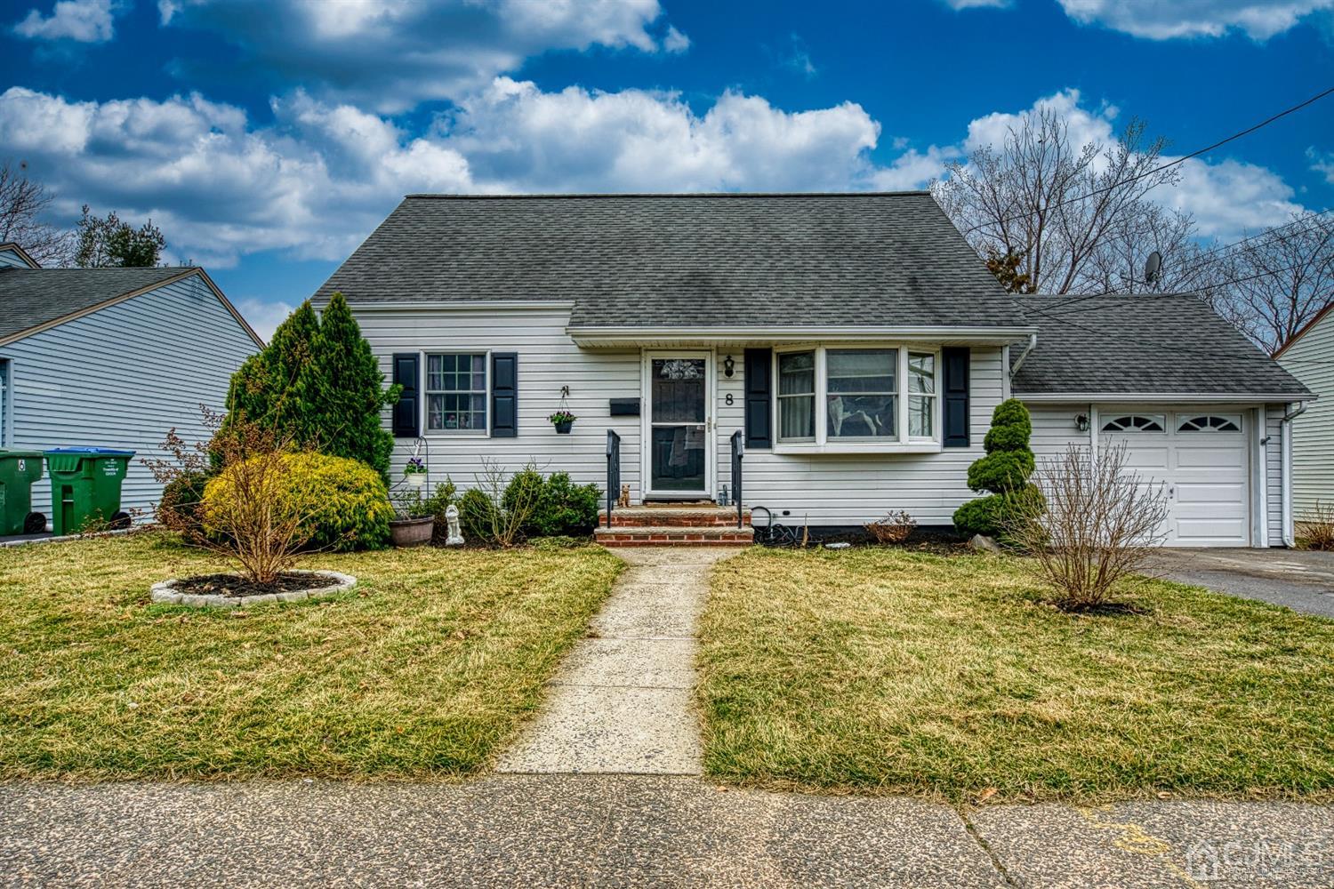 8 Clausen Road Edison, NJ 08817 - Photo 16 of 17 a front view of a house with a yard outdoor seating and garage