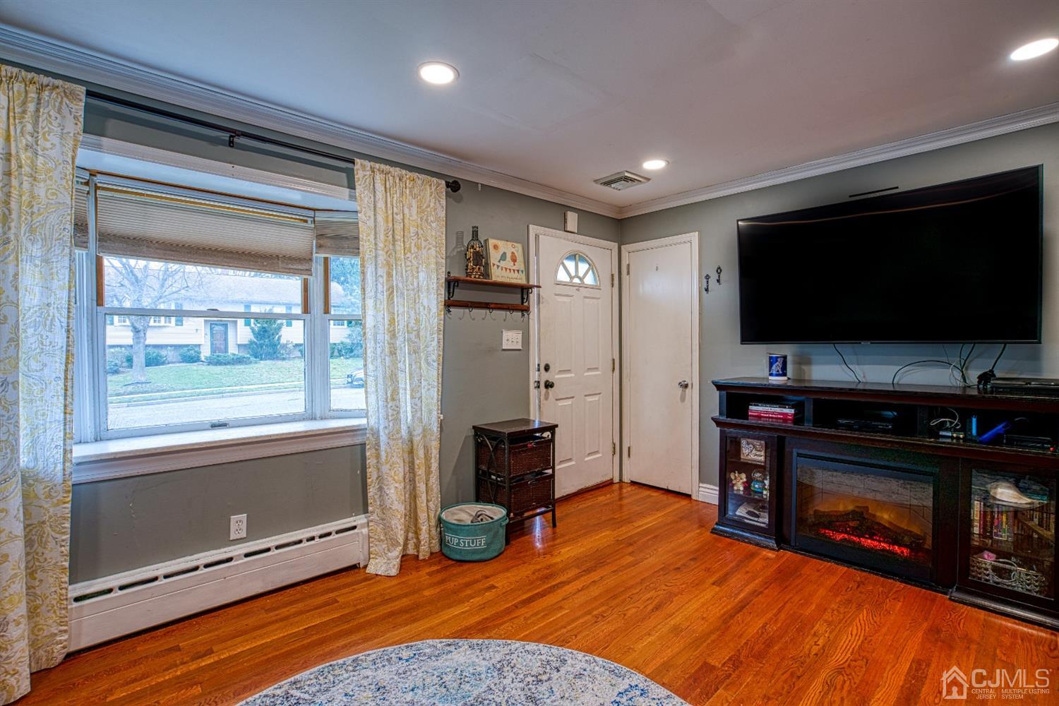8 Clausen Road Edison, NJ 08817 - Photo 3 of 17 a living room with furniture and a flat screen tv