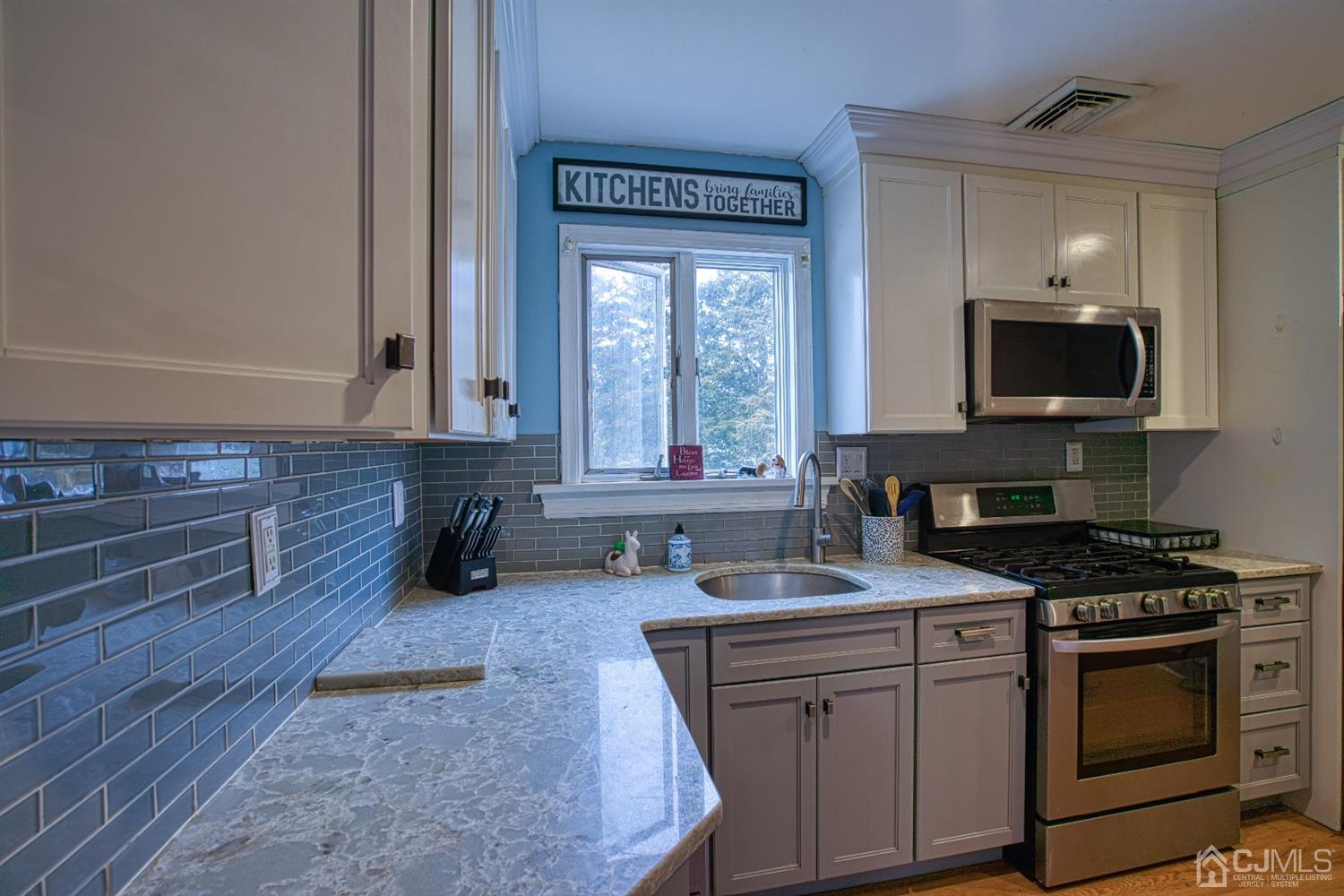 8 Clausen Road Edison, NJ 08817 - Photo 4 of 17 a kitchen with a stove a sink and a microwave