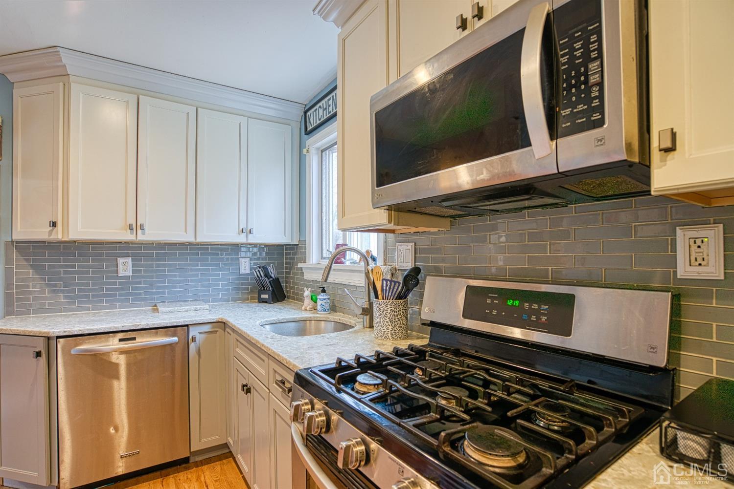 8 Clausen Road Edison, NJ 08817 - Photo 5 of 17 a kitchen with a stove and a microwave