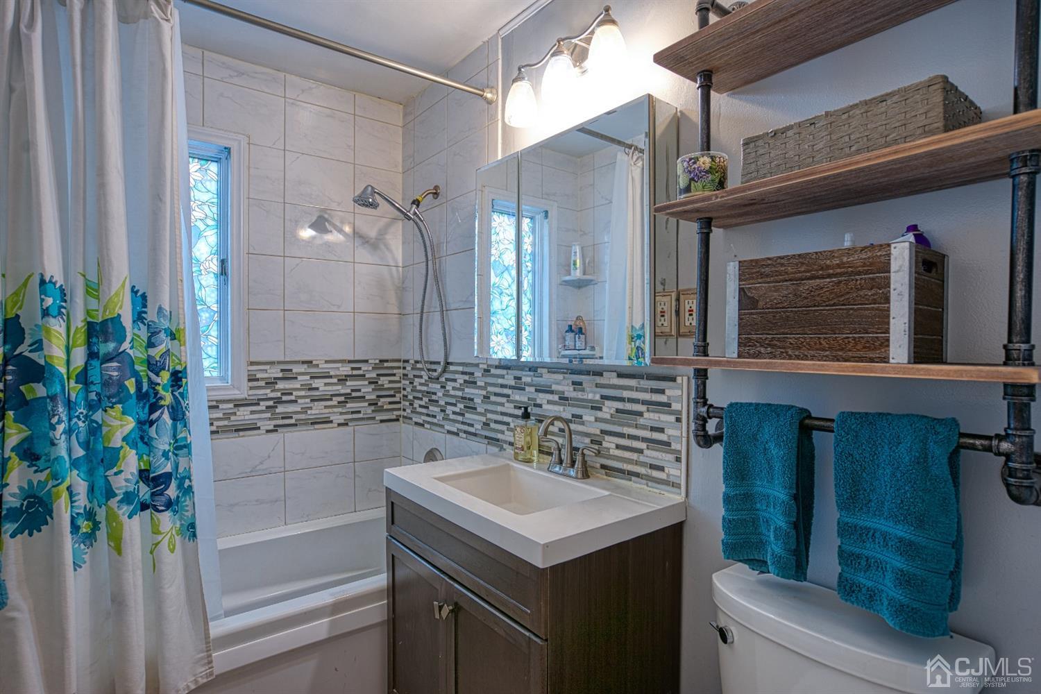 8 Clausen Road Edison, NJ 08817 - Photo 7 of 17 a bathroom with a sink and a mirror