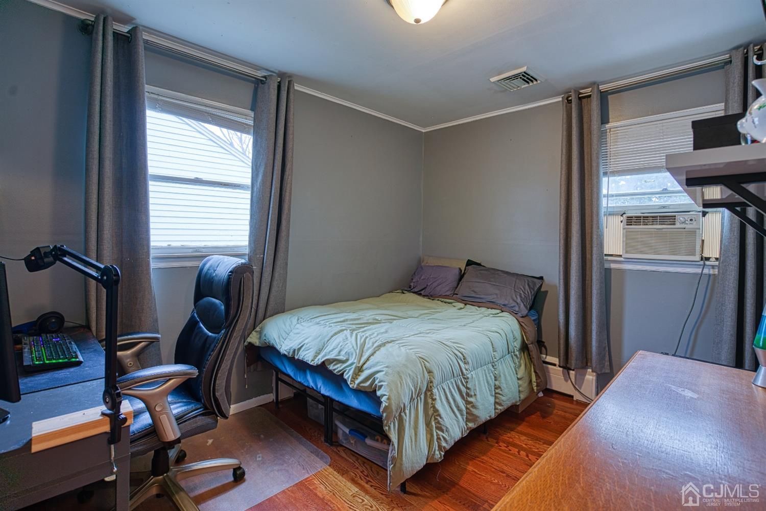 8 Clausen Road Edison, NJ 08817 - Photo 8 of 17 a bedroom with a bed and a window