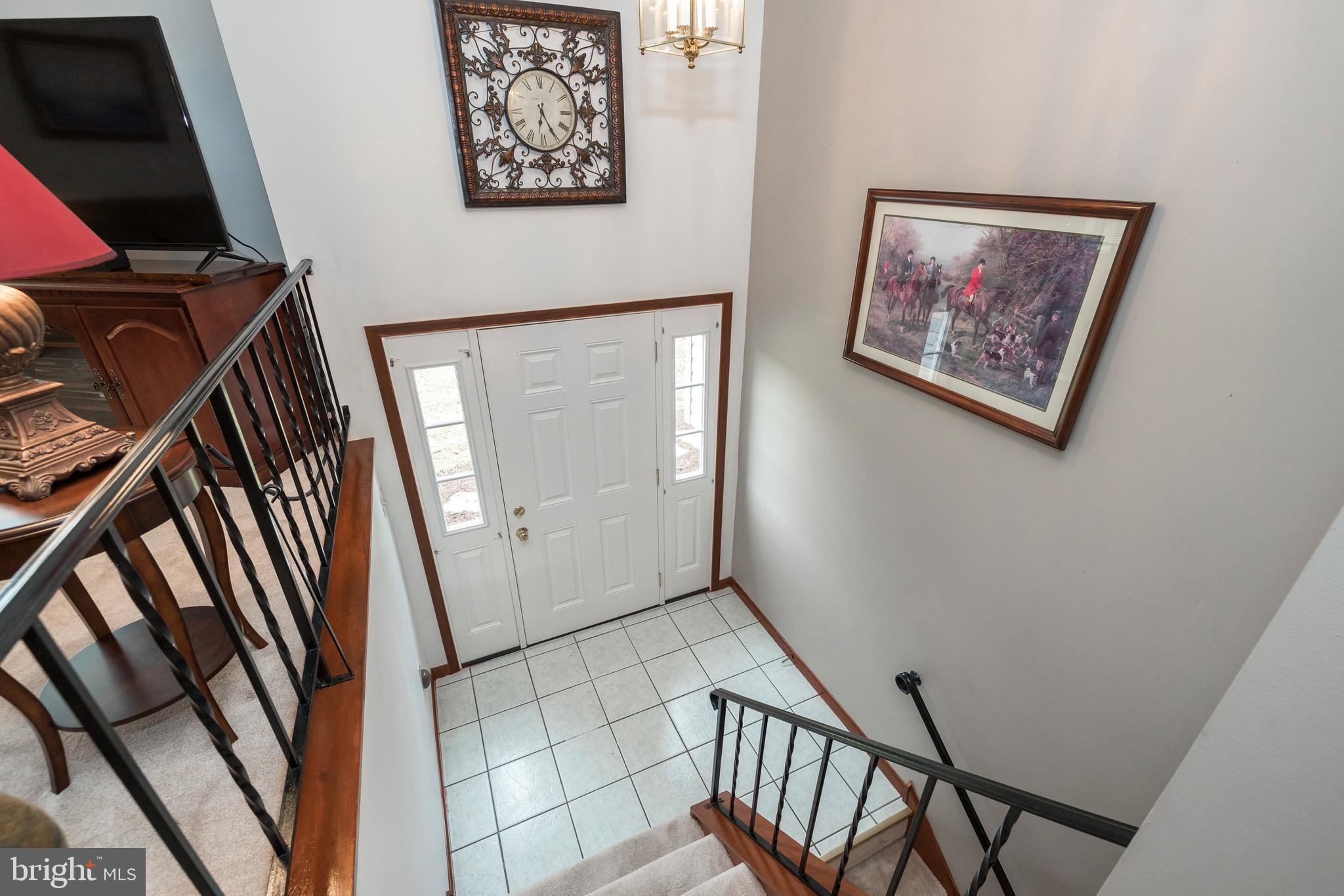 Striking Front Foyer with Custom Tile Floor!