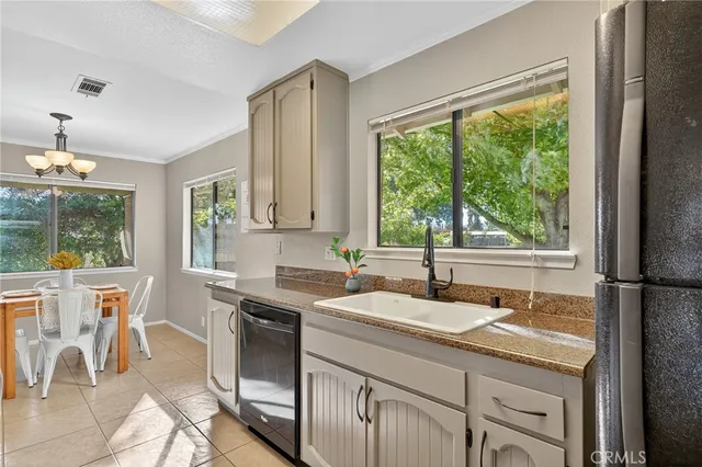 a kitchen with granite countertop a sink and a refrigerator