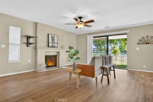 a workspace with wooden floor a fireplace and a window
