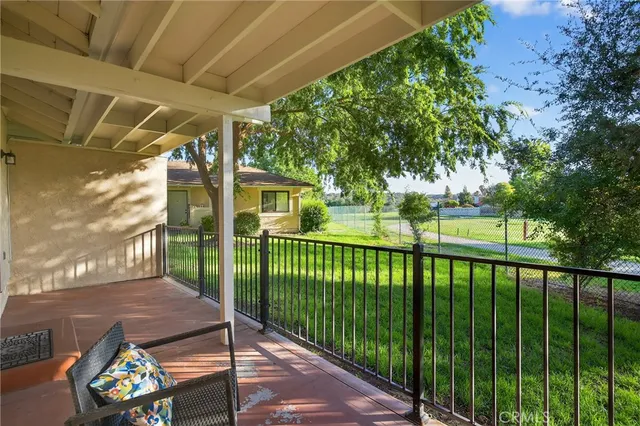 a view of a porch with furniture and garden