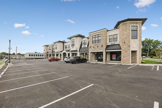 a front view of a building with parking space