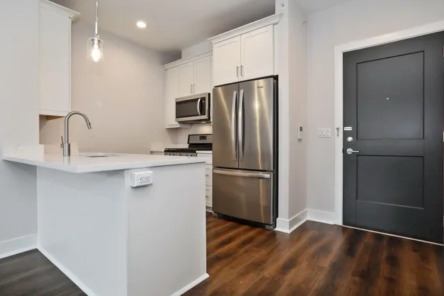 a kitchen with stainless steel appliances a refrigerator and a sink