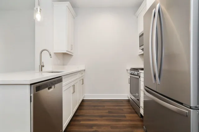 a kitchen with a refrigerator and a sink