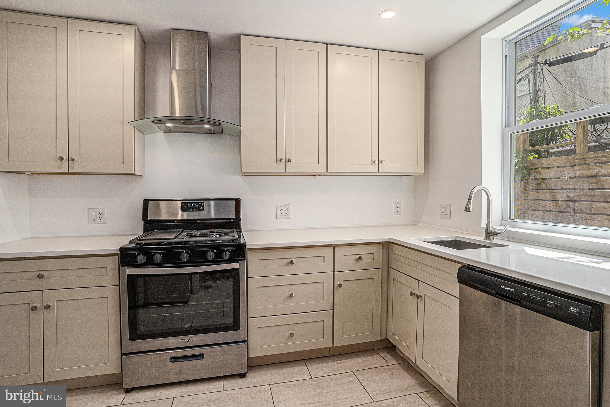 2128 Fernon Street Philadelphia, PA 19145 - Photo 11 of 30 a kitchen with cabinets appliances and a sink