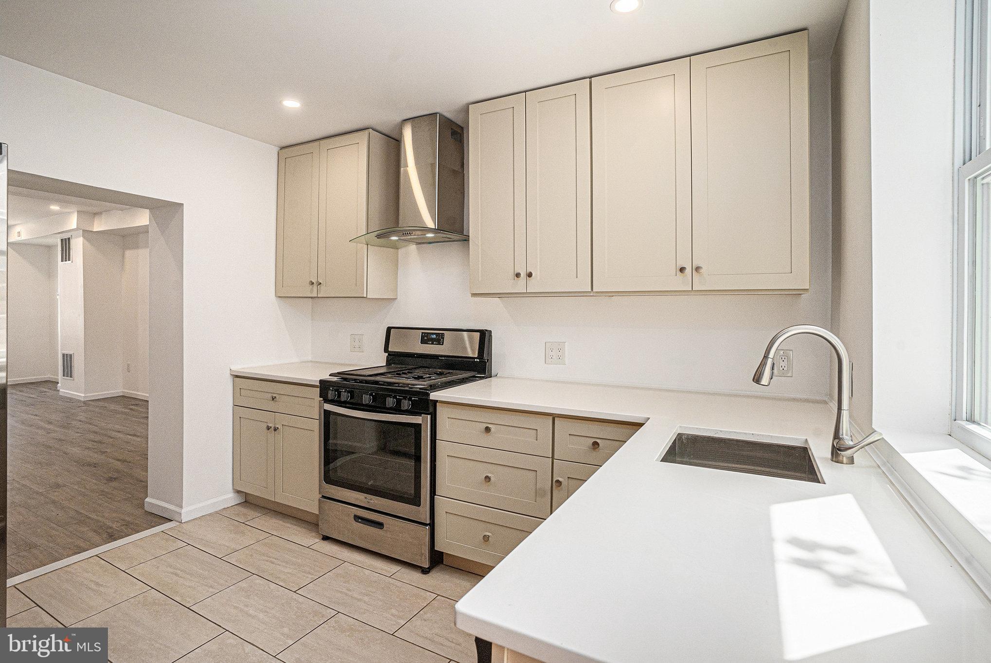 2128 Fernon Street Philadelphia, PA 19145 - Photo 12 of 30 a kitchen with white cabinets and appliances