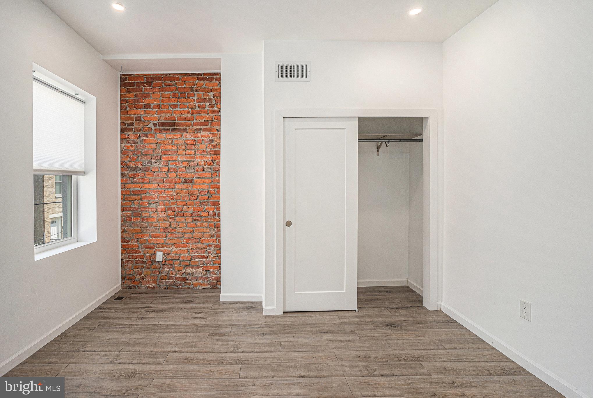 2128 Fernon Street Philadelphia, PA 19145 - Photo 16 of 30 a view of an empty room with wooden floor and a window