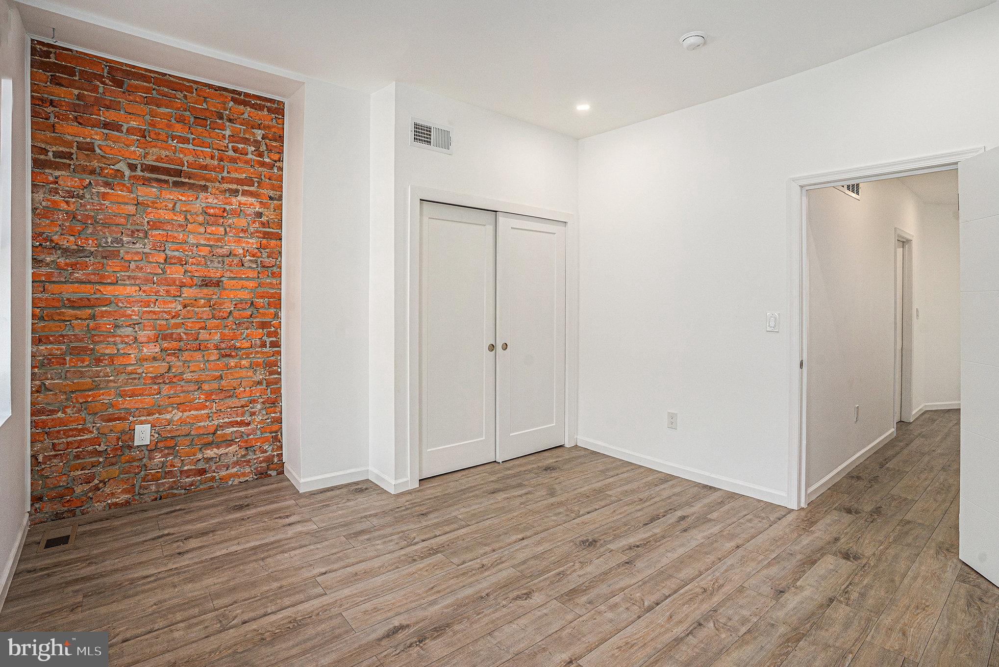 2128 Fernon Street Philadelphia, PA 19145 - Photo 17 of 30 a view of an empty room with wooden floor and a window
