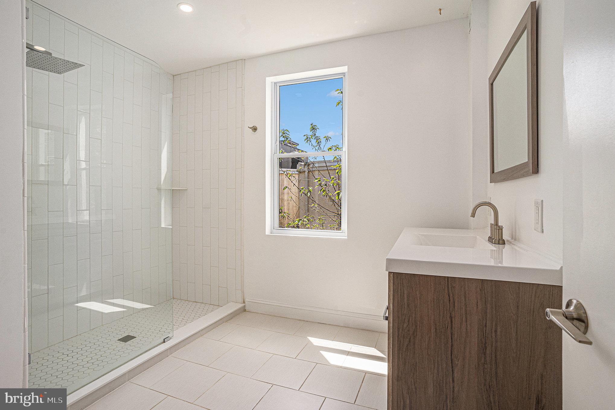 2128 Fernon Street Philadelphia, PA 19145 - Photo 19 of 30 a bathroom with a sink and a mirror