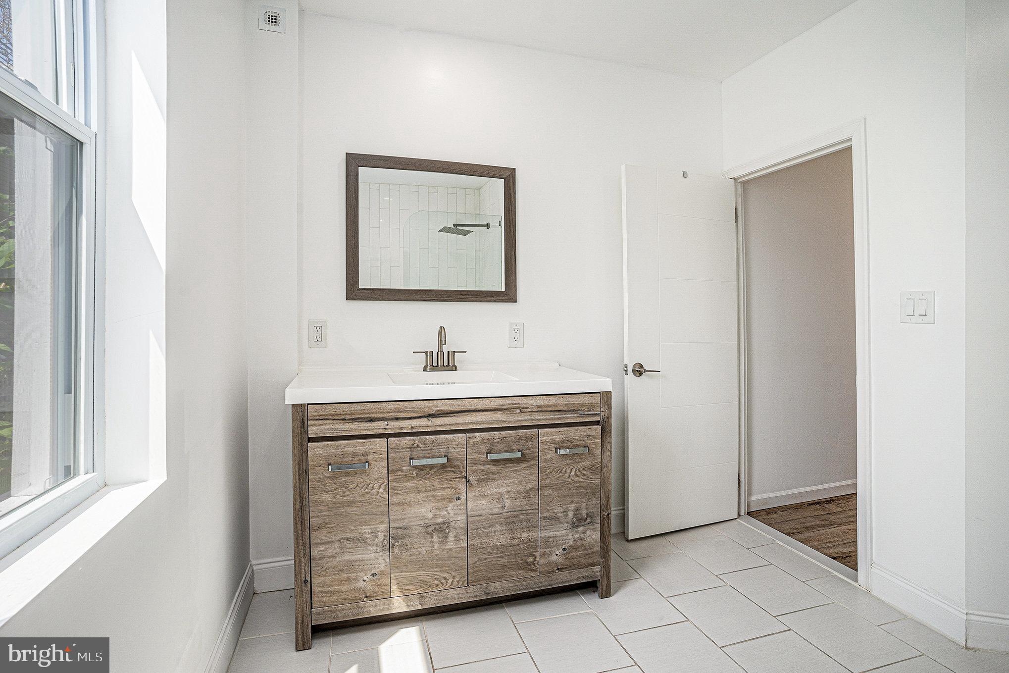 2128 Fernon Street Philadelphia, PA 19145 - Photo 20 of 30 a bathroom with a sink a vanity and a mirror