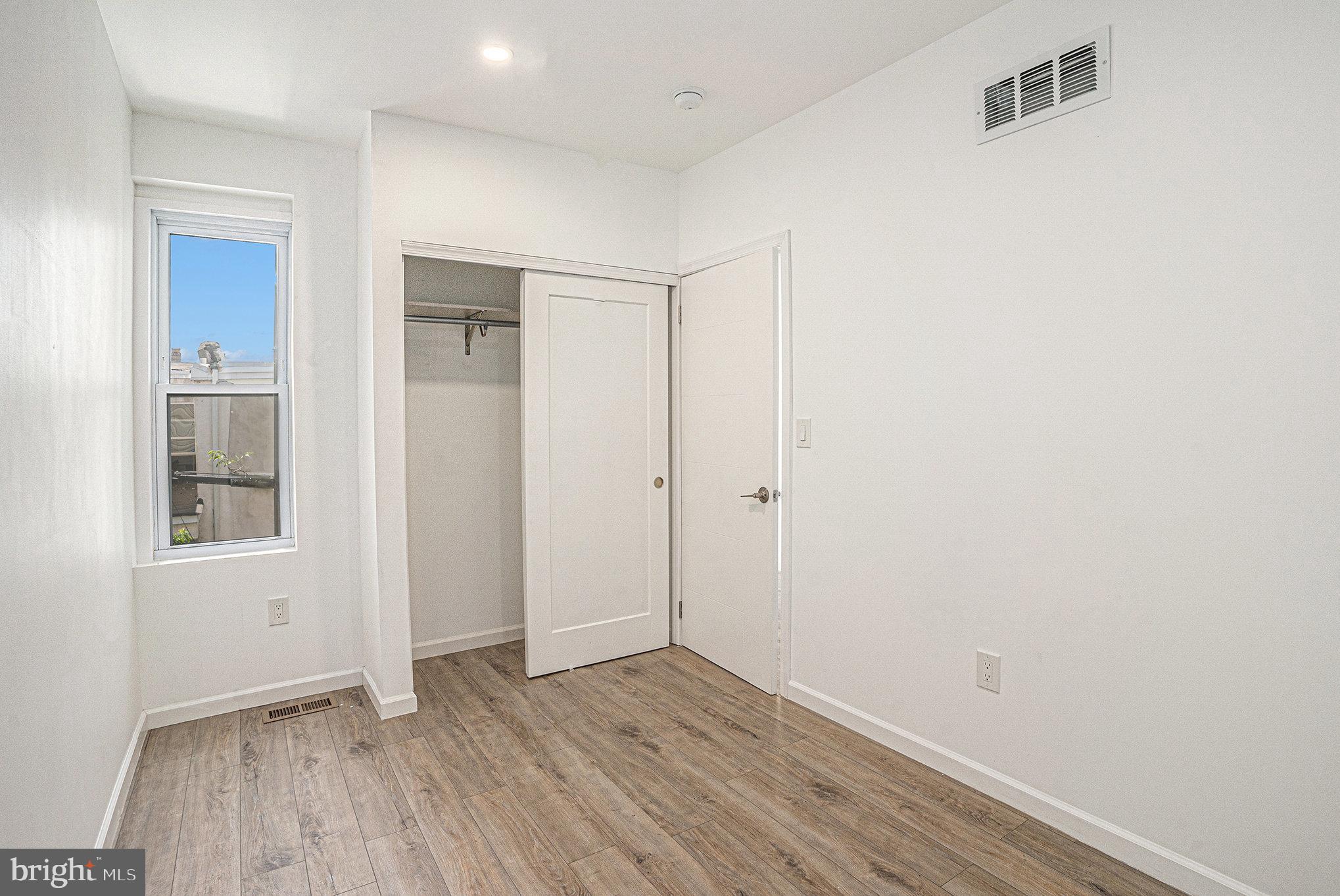 2128 Fernon Street Philadelphia, PA 19145 - Photo 22 of 30 an empty room with wooden floor and windows
