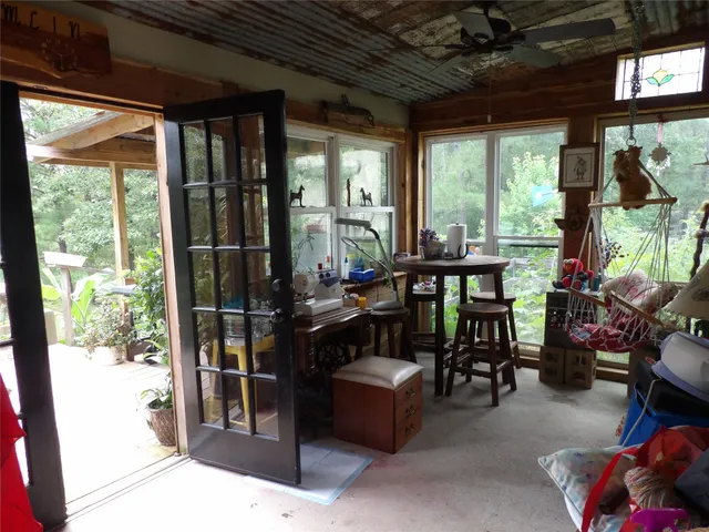 a view of a balcony with chairs and a potted plant