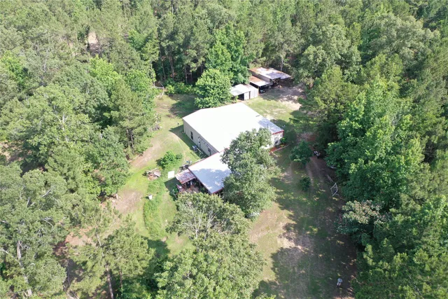 a backyard of a house with a yard and fountain in the back