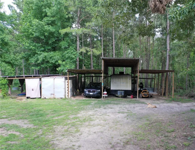 a view of a chair and table in the back yard
