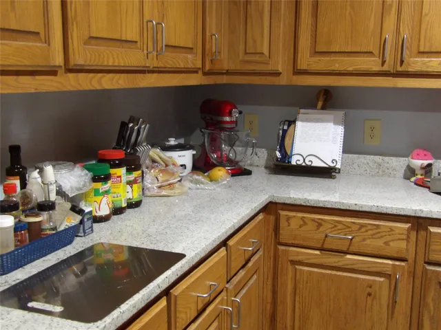 a kitchen with a sink dishwasher and cabinets with wooden floor