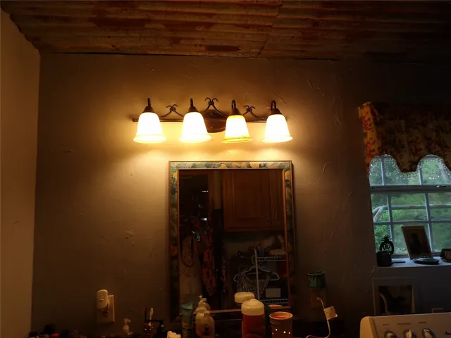 a bathroom with a toilet sink and mirror