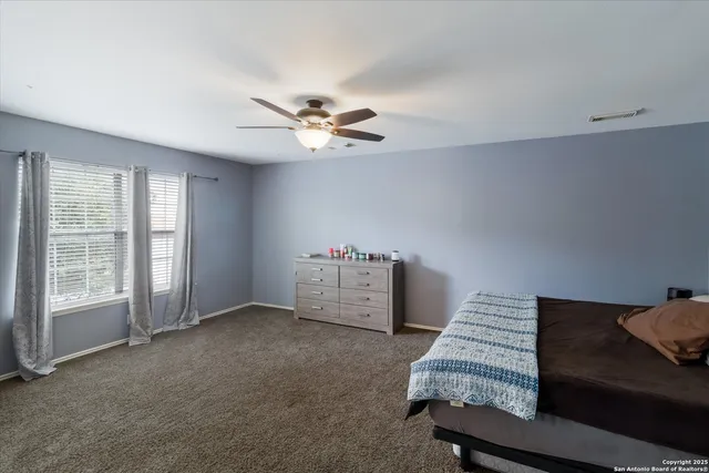 a spacious bathroom with a tub shower and mirror