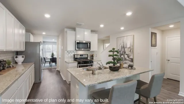 a kitchen with sink a counter and chairs