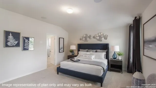 a bedroom with a bed table and a painting