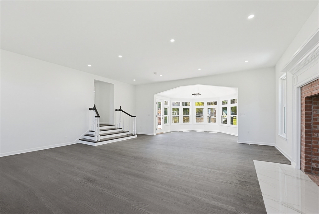 175 Pleasant Street Upton, MA 01568 - Photo 15 of 39 an empty room with wooden floor and white walls
