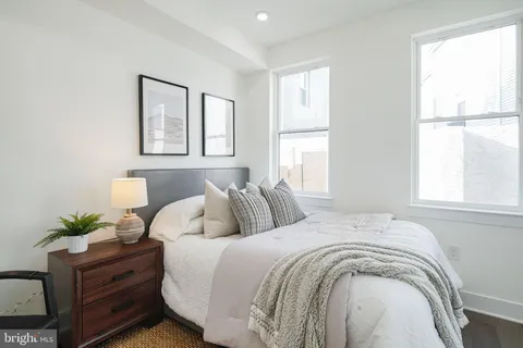 a spacious bedroom with a bed and a window