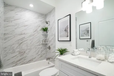 a bathroom with a sink a toilet and tub