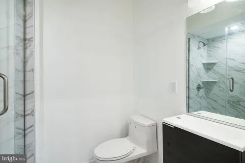 a white toilet sitting next to a bathroom sink