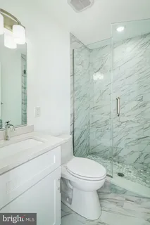 a bathroom with a toilet a sink and shower