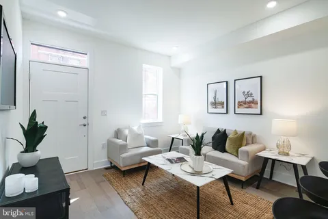 a living room with furniture potted plant and window