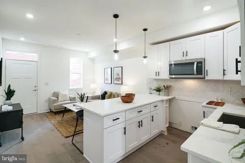 a kitchen that has a sink and a stove in it