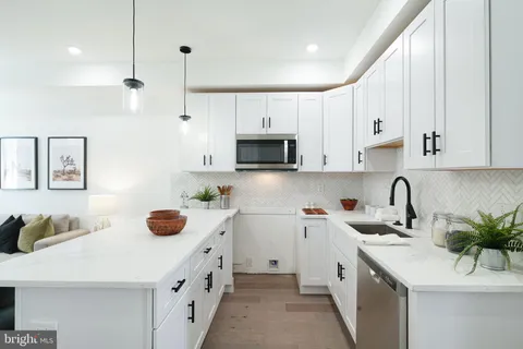 a kitchen with a sink a stove and cabinets