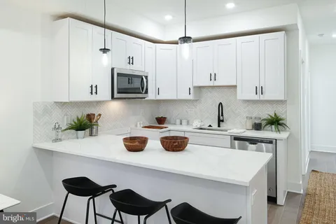 a kitchen with a table chairs and microwave