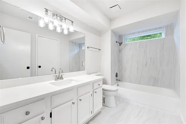 a bathroom with a double vanity sink mirror double and a bathtub