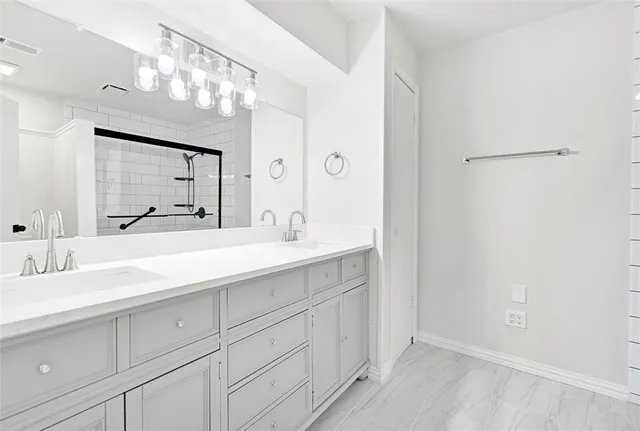 a bathroom with a double vanity sink mirror and