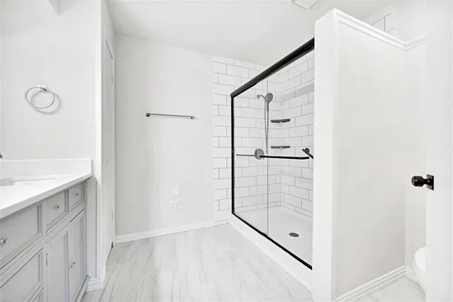a bathroom with a shower and a sink