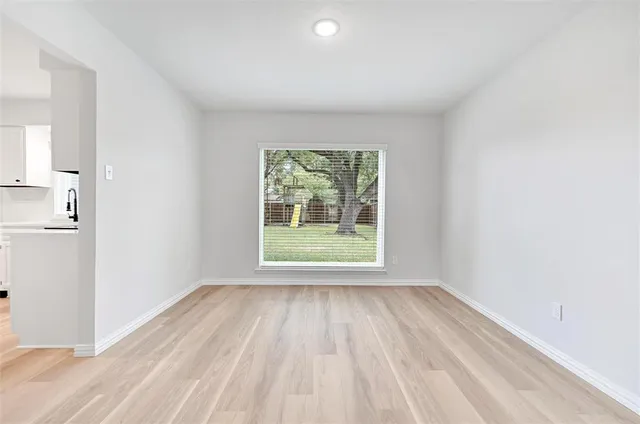 a view of room with window and hardwood floor