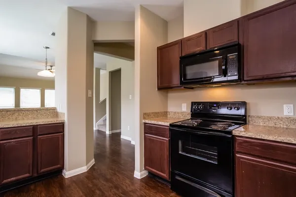 a kitchen with a stove microwave and sink