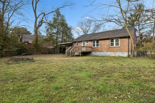 a house that has a tree in front of it