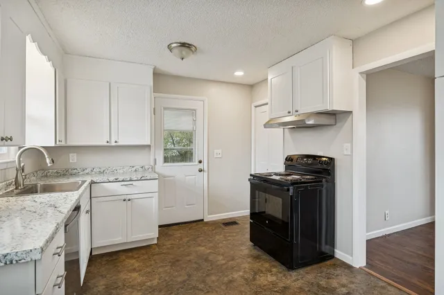 a kitchen with a stove and a sink
